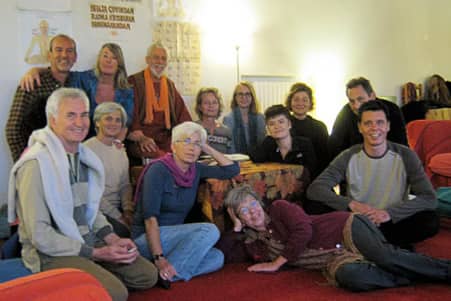 Small group satsang gathered in a living room.