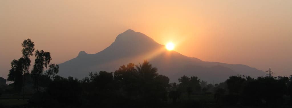 Golden sunrise over mountain silhouette — spiritual atmosphere