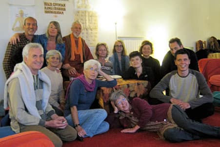 Historic Muz Murray mantra workshop photo showing a small satsang-style gathering in a home setting.